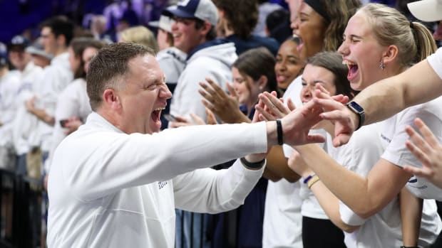 Penn State coach Mike Rhoades celebrates with fans after the Nittany Lions' win over Ohio State at the Bryce Jordan Center.